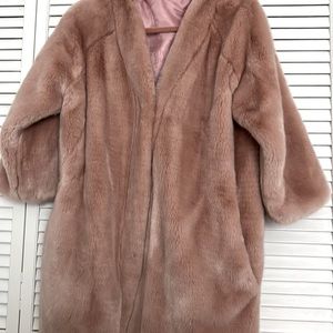 Pink supper soft Faux fur with slash pockets. Shawl collar with hook closures.